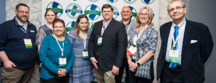 A Group of People Posing in Front of the LSRP Logo